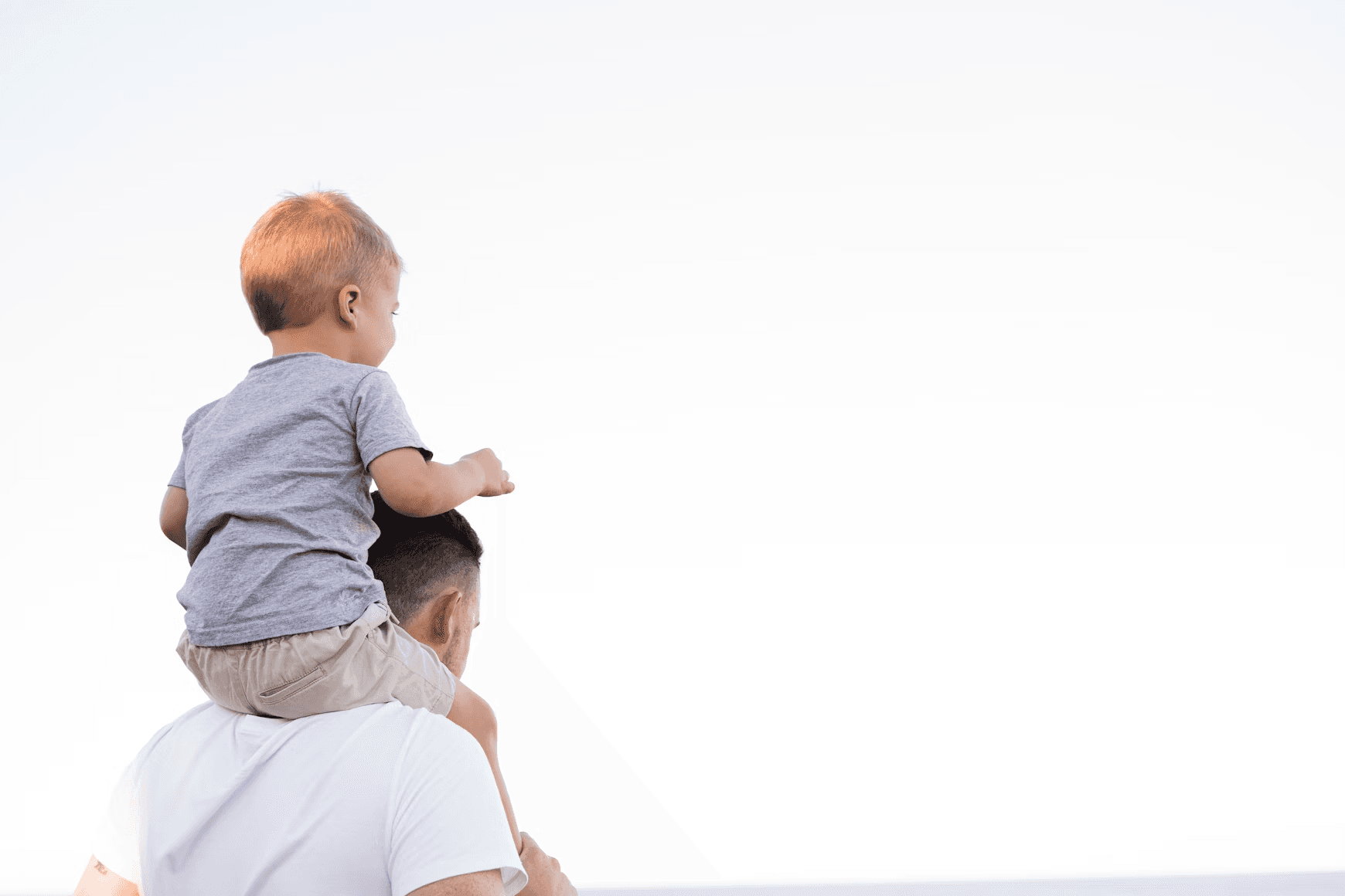 Parent holding child in warm outdoor setting